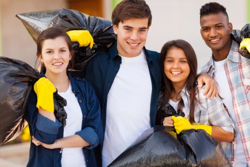 Workers preparing commercial waste for collection at a business site